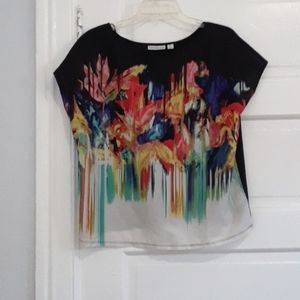 A artsy floral blouse. Yellow, reds, and blues